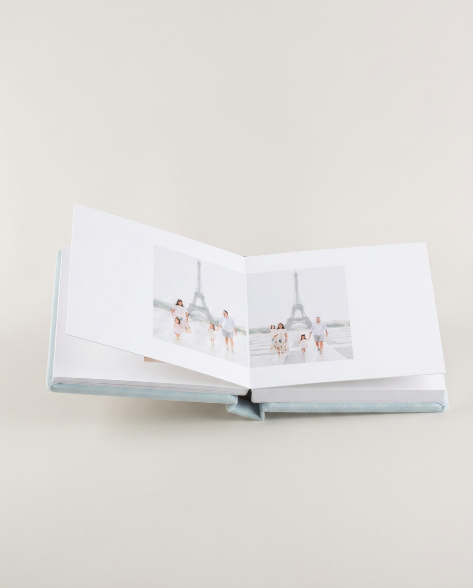 A family volume opened to photographs of children in Paris