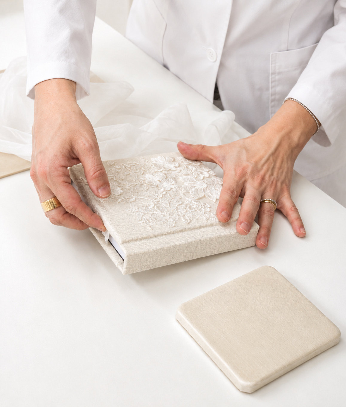 A bride holding a pearl-trimmed couture album made in Italy