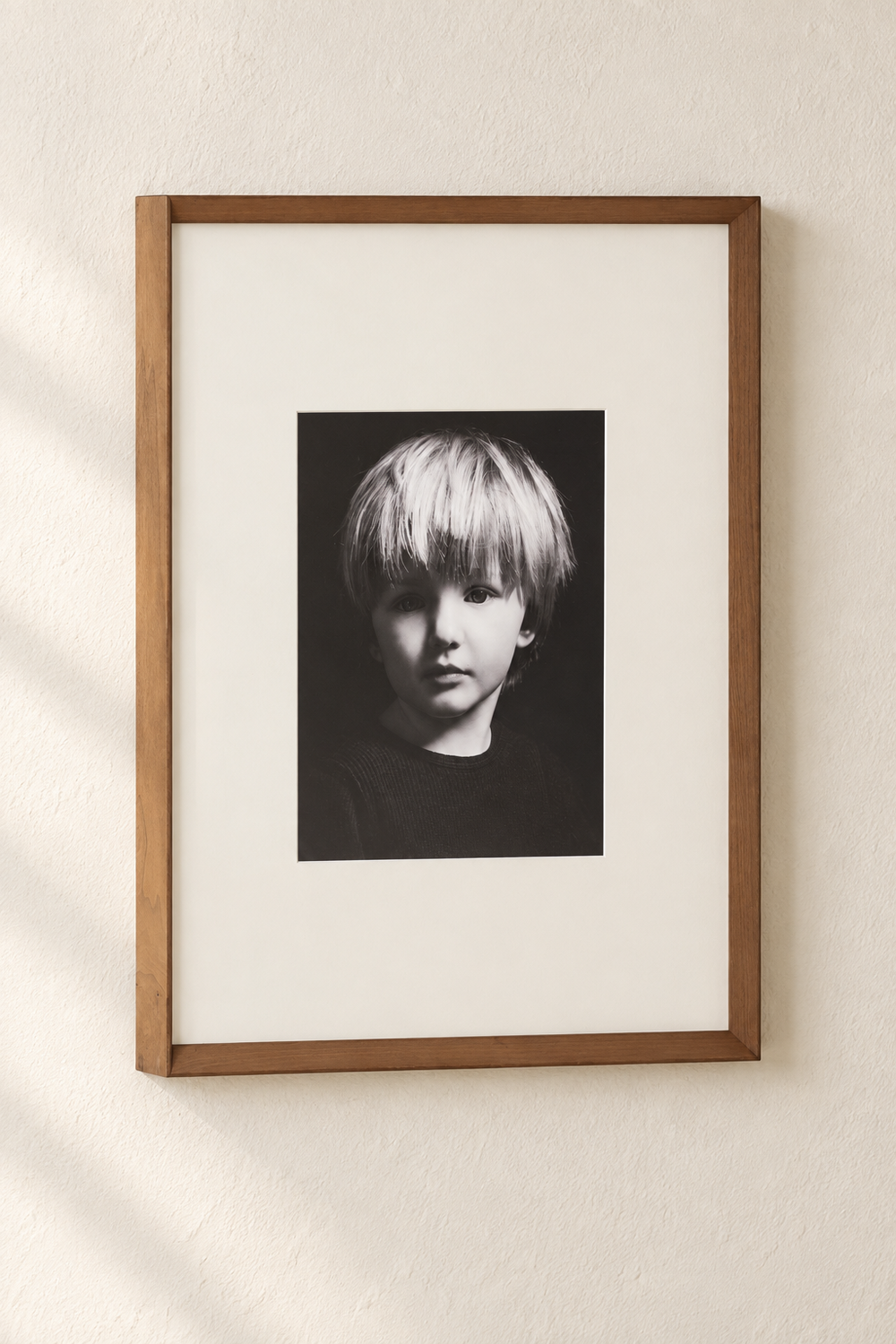Black and white child portrait in a warm wood frame