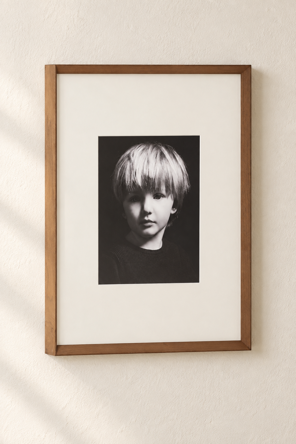Black and white child portrait in a warm wood frame
