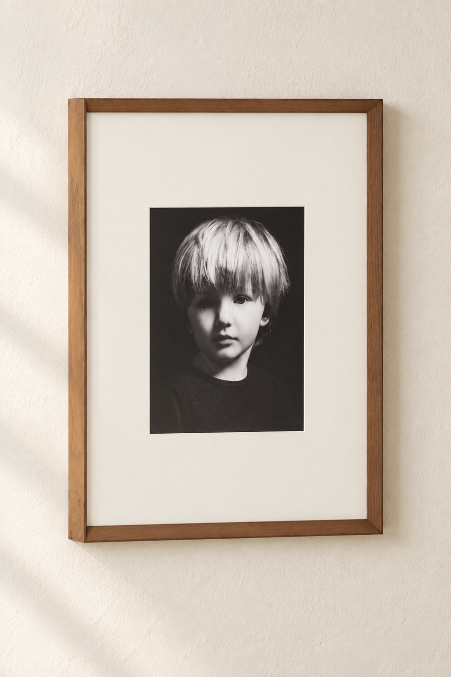 Black and white child portrait in a warm wood frame
